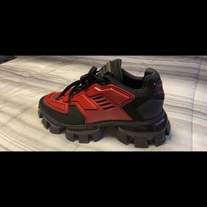Prada red and black men fashion sneaker. Used fairly but still look new